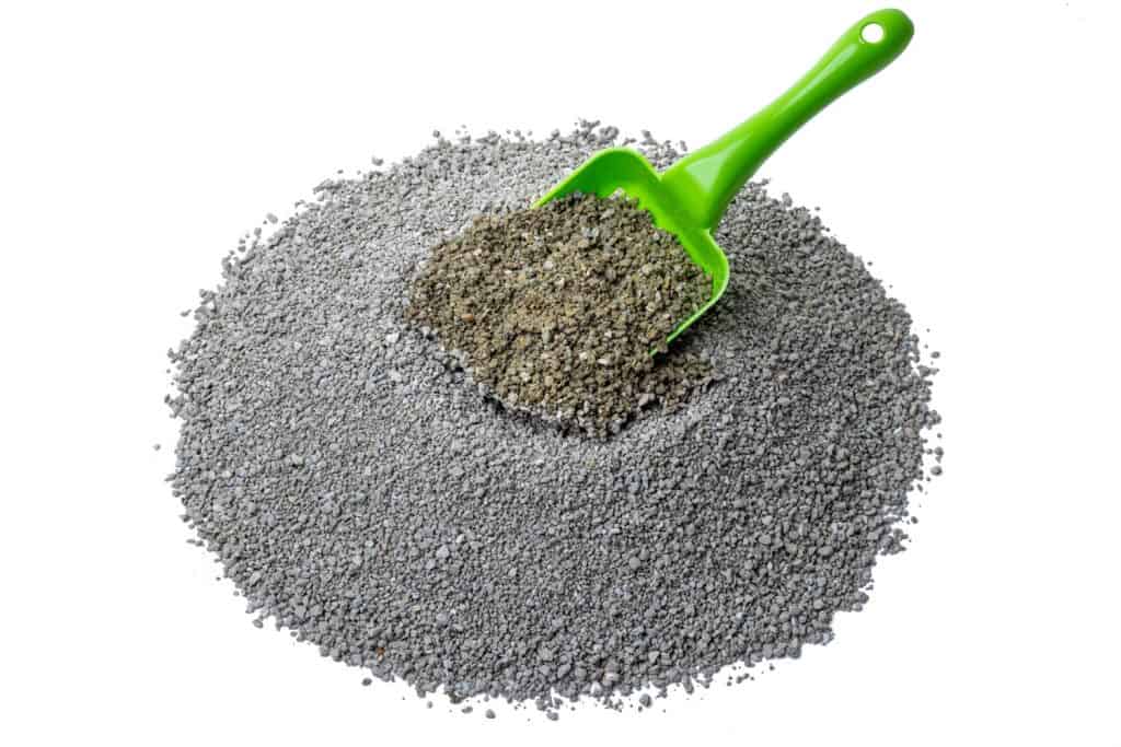 Scooping cat litter on a white background