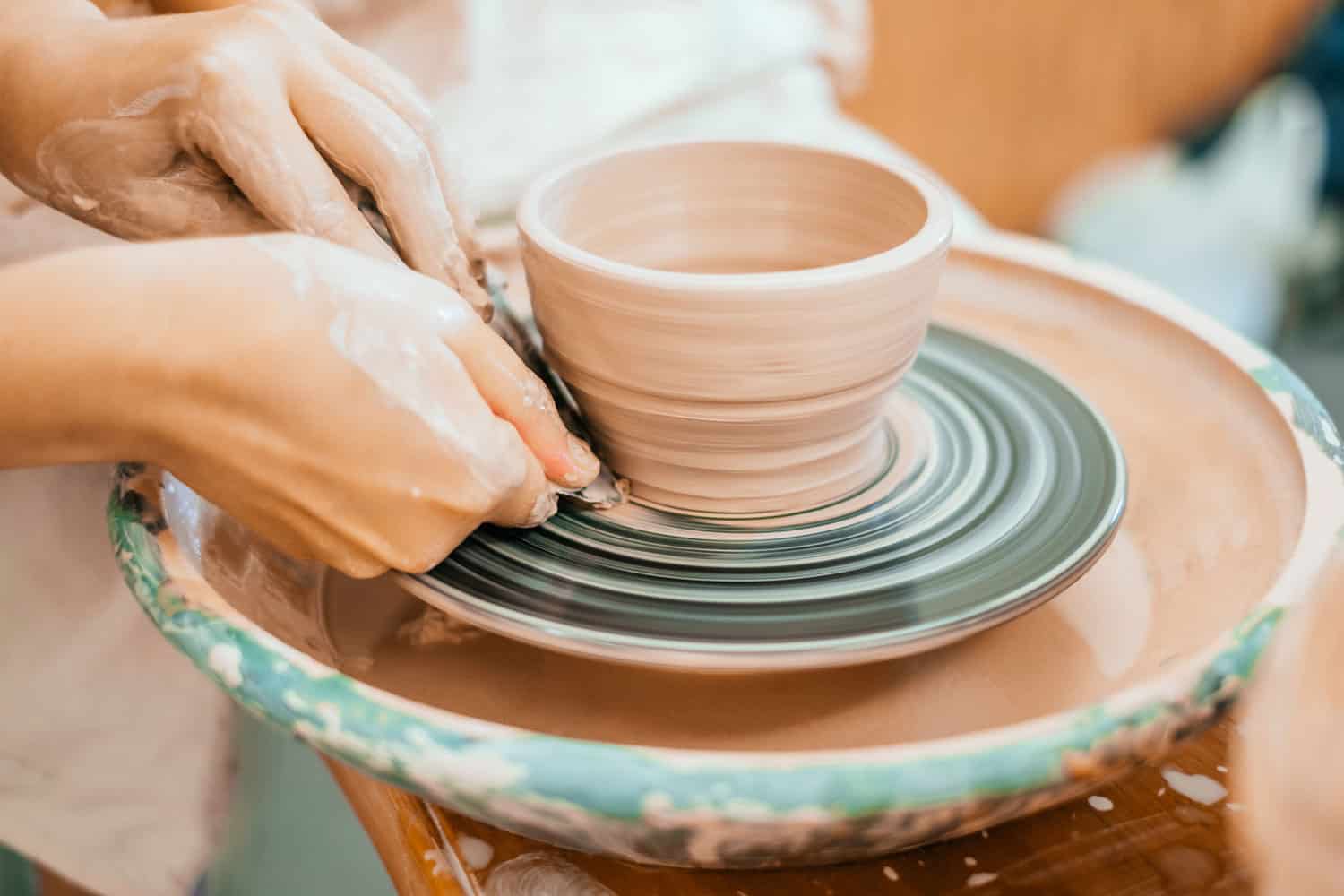 Woman molding a clay pot