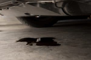 Oil leak or drop from engine of car on concrete floor , check and maintenance auto service - What Is The Best Kitty Litter For Oil Stains And Spills