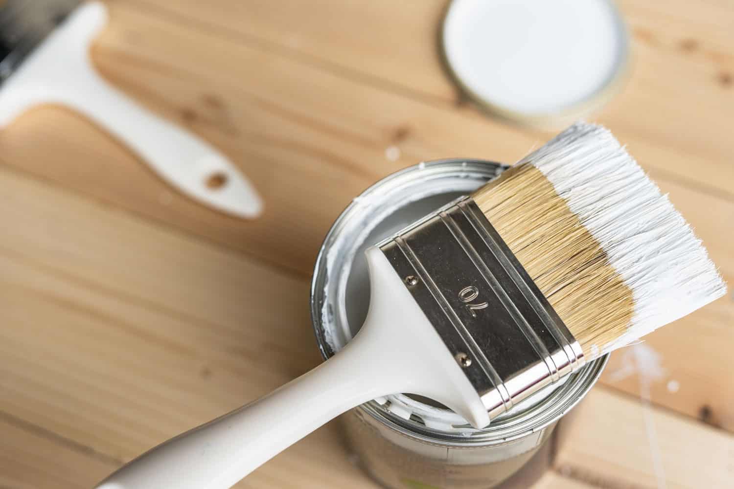 A paint brush dipped in white paint