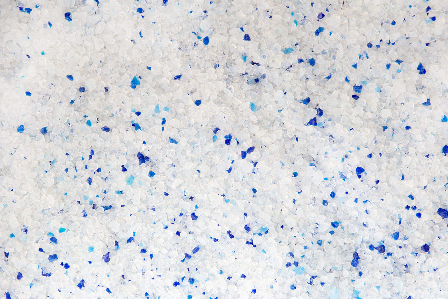 Silica gel white with blue crystals cat litter close-up. Abstract background of pure silica gel crystals.
